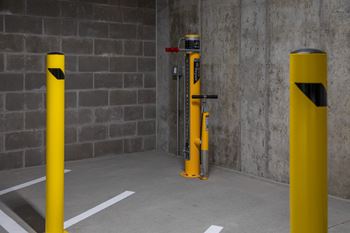 A yellow pole with a black stripe on it.